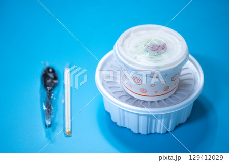 Kalguksu in a plastic box on a blue background. Food delivery Kalguksu in a plastic box on a blue background. Food delivery 129412029