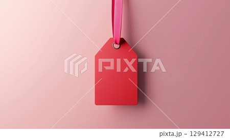 Paper price tag label red brand name with rope on solid background 129412727