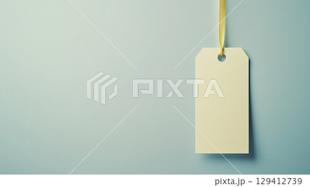 Paper price tag label white brand name with rope on solid blue background 129412739
