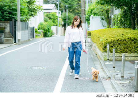 ペットと散歩する若い女性	 129414093