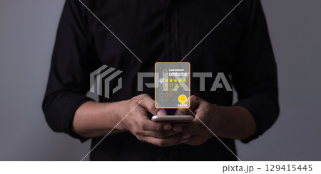 Customer Review, Young Man hand holding Smart Phone with five star to review and give 5 stars 129415445