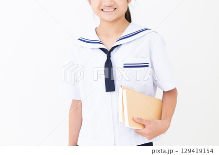 本を持つ夏の学生服姿の中学生女子 129419154