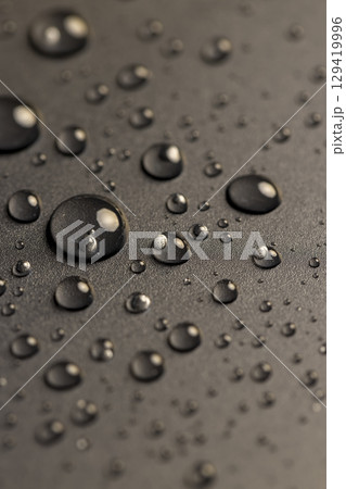 plastic covered with water drops, details of the wet part of an object made of black plastic plastic covered with water drops, details of the wet part of an object made of black plastic 129419996