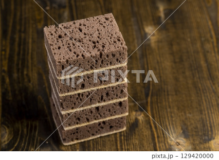 sponge with of holes for good foaming of detergents and is used for cleaning, brown sponge for washing dirty dishes 129420000