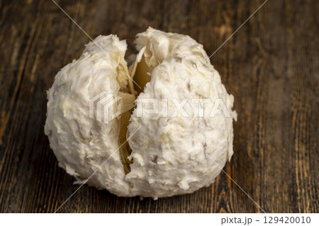 sweet and peeled citrus, delicious fresh citrus on a wooden board, closeup sweet and peeled citrus, delicious fresh citrus on a wooden board, closeup 129420010