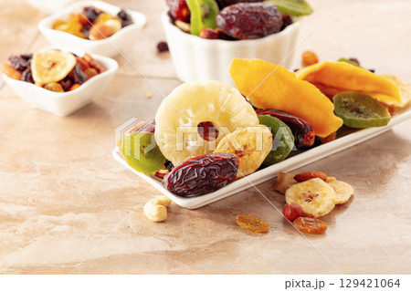 Dried tropical fruits with various nuts and raisins. 129421064