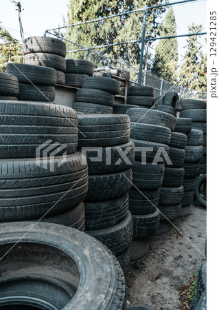 Used Worn Out Car Tires Piled Outdoors Used Worn Out Car Tires Piled Outdoors 129421285