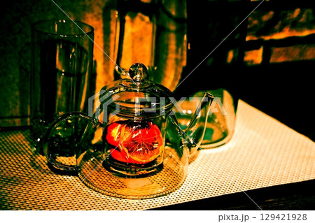 lemon in a glass teapot on the kitchen table. Winter holidays concept. lemon in a glass teapot on the kitchen table. Winter holidays concept. 129421928
