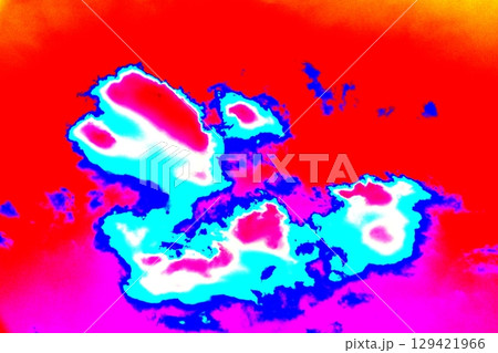 Beautiful patterns of clouds on a clear sky background. Changed color scheme. Colorful background. Beautiful patterns of clouds on a clear sky background. Changed color scheme. Colorful background. 129421966