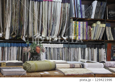 Many different colorful fabric samples as background, closeup. 129421996