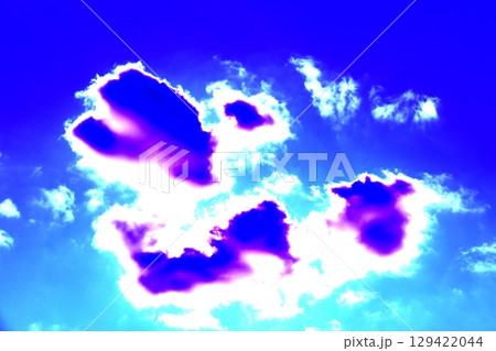Beautiful patterns of clouds on a clear sky background. Changed color scheme. Colorful background. 129422044