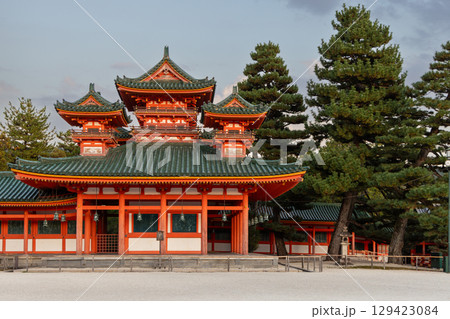 Framed by ancient pines, vivid facade of Heian Jingu Shrine in Kyoto glows in soft light Framed by ancient pines, vivid facade of Heian Jingu Shrine in Kyoto glows in soft light 129423084