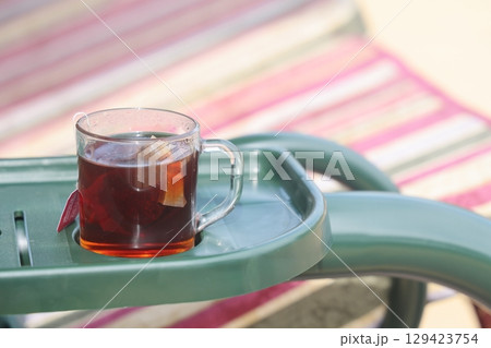 A cup of herbal tea in the country, a glass of tea on the country swing. 129423754