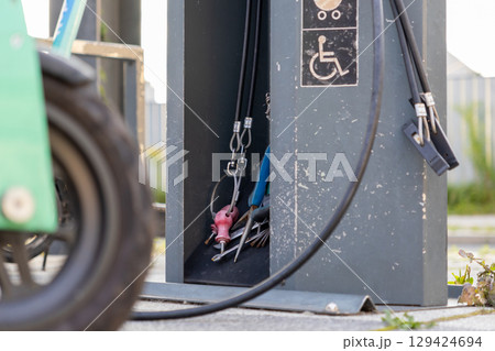 Public service station offering essential tools for bicycle repair and maintenance, featuring accessibility symbols, reflecting urban infrastructure and sustainable transport Public service station offering essential tools for bicycle repair and maintenance, featuring accessibility symbols, reflecting urban infrastructure and sustainable transport 129424694