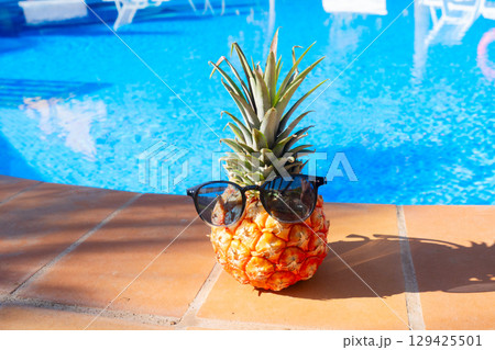 pinapple near swimming pool 129425501