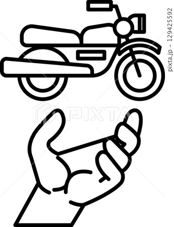 A hand is holding a motorcycle 129425592