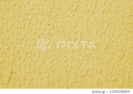 Rough yellow colored concrete or plaster wall texture background Rough yellow colored concrete or plaster wall texture background 129426004