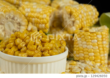 Bowl Of Preserved Corn Kernels With Fresh Corn Cobs Around. Bowl Of Preserved Corn Kernels With Fresh Corn Cobs Around. 129426050