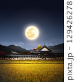 Korean traditional holiday Chuseok banner background, a bountiful Chuseok thank you card background with an autumn full moon, a hanok tile-roofed house, and ears of rice. 129426278