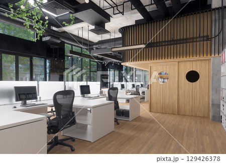 Modern office space with empty desks and computers. Contemporary workspace for business and productivity. 129426378