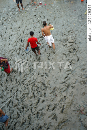 4th October 2023, Babughat, Kolkata, West Bengal, India. Walking in muddy terrain at Babu Ghat During low tide 4th October 2023, Babughat, Kolkata, West Bengal, India. Walking in muddy terrain at Babu Ghat During low tide 129429345