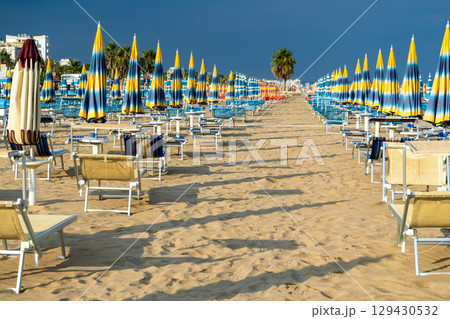 Beach with Umbrellas and Deck Chairs on Sand. Palm tree 129430532