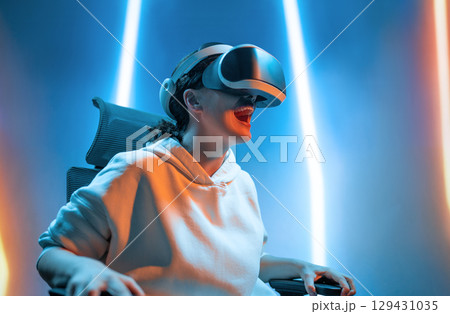 Woman with VR virtual reality goggles Woman with VR virtual reality goggles 129431035