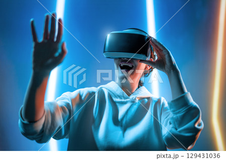 Woman with VR virtual reality goggles 129431036