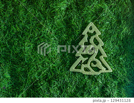 Christmas tree toy with green needles in the background 129431128