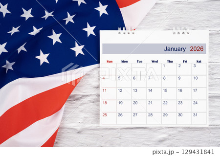 January 2026 Monthly desk calendar and United States of America flag, Flat lay. 129431841