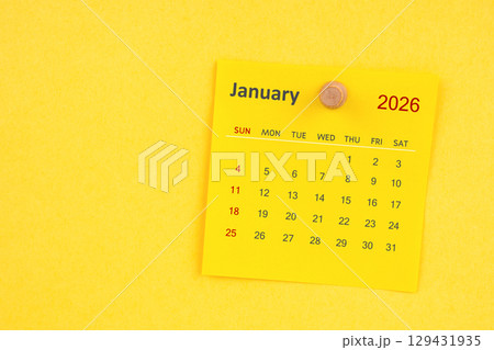 January 2026 calendar sheet with thumbtack on yellow color background. January 2026 calendar sheet with thumbtack on yellow color background. 129431935
