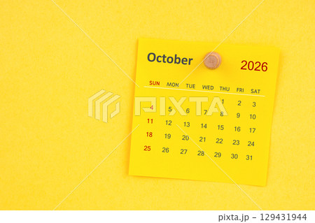 October 2026 calendar sheet with thumbtack on yellow color background. October 2026 calendar sheet with thumbtack on yellow color background. 129431944