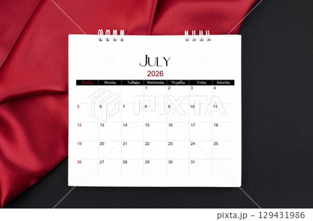 July 2026 Monthly desk calendar with red silk on black color leather background. 129431986