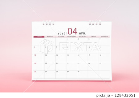 April blank desk calendar for 2026 year on pink color background. 129432051