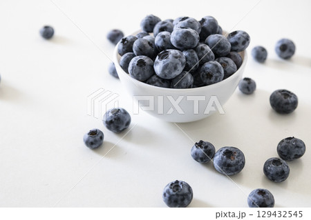 Blueberry is tasty, healthy and delicious fruits. Fresh blueberries in white bowl. Wild blueberries in white plate on white background. Blueberry is tasty, healthy and delicious fruits. Fresh blueberries in white bowl. Wild blueberries in white plate on white background. 129432545