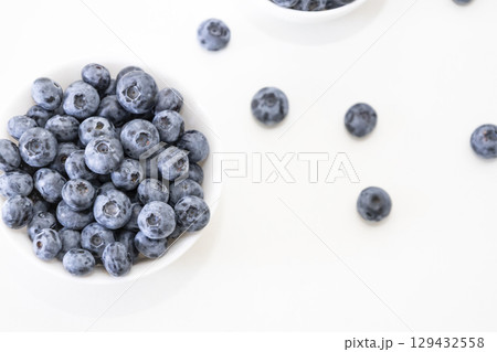 Blueberry is tasty, healthy and delicious fruits. Fresh blueberries in white bowl. Wild blueberries in white plate on white background. Blueberry is tasty, healthy and delicious fruits. Fresh blueberries in white bowl. Wild blueberries in white plate on white background. 129432558