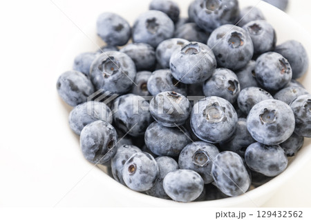 Blueberry is tasty, healthy and delicious fruits. Fresh blueberries  in white bowl. Wild blueberries in white plate on white background. 129432562