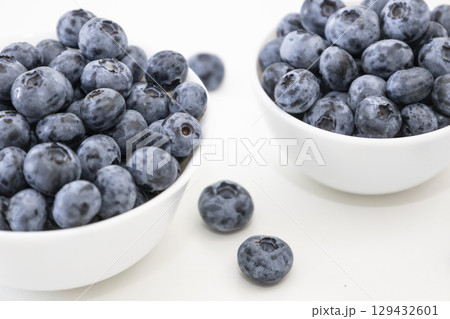 Blueberry is tasty, healthy and delicious fruits. Fresh blueberries in white bowl. Wild blueberries in white plates on white background. Blueberry is tasty, healthy and delicious fruits. Fresh blueberries in white bowl. Wild blueberries in white plates on white background. 129432601