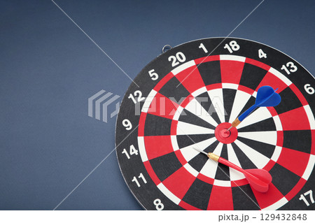 Dart board on dark blue background. Top view 129432848