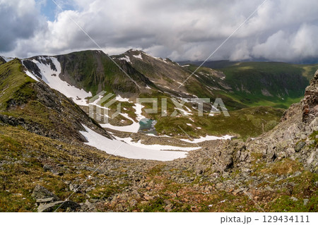 The mountain lake is located in the highlands 129434111