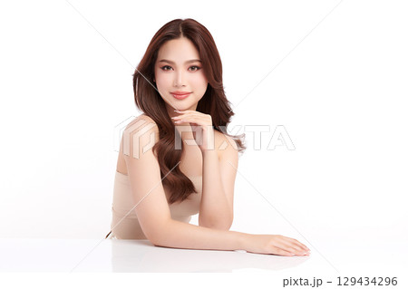 A beautiful young Asian woman with clean, fresh skin against a white background. Skincare, facial treatment, cosmetology, beauty, and spa. An elegant portrait of an Asian woman. A beautiful young Asian woman with clean, fresh skin against a white background. Skincare, facial treatment, cosmetology, beauty, and spa. An elegant portrait of an Asian woman. 129434296