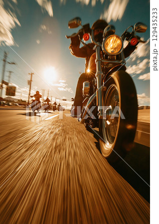 Modern bikers enjoy a group ride along the highway on a hot summer day 129435233