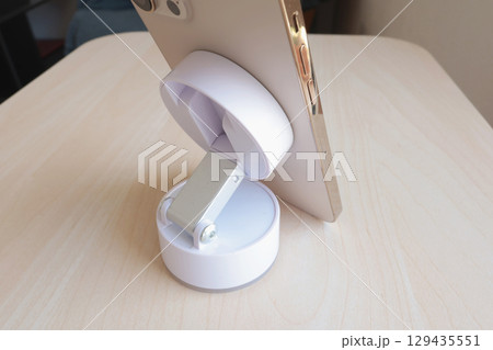 White stand with suction cup and magnet for smartphone. Technology and equipment. 129435551