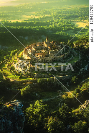 Knights in a vast landscape engage in battle near a fortress during a historic campaign Knights in a vast landscape engage in battle near a fortress during a historic campaign 129435799