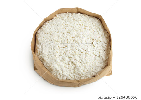 White flour in a paper bag isolated on white background. Top view. Flat lay. 129436656