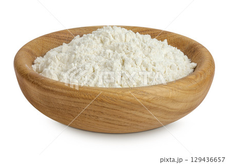 White flour in wooden bowl isolated on white background 129436657