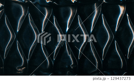 Metal uneven pattern. Old texture. Glossy steel diamond wave wall. Black distressed uneven old abstract defocused scratch background. 129437273