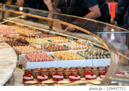 Various assortment of desserts confectionery on the counter in a bakery 129437721