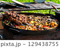 Grilled Meat Skewers and Roasted Vegetables on Open Fire 129438755