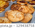Freshly baked sesame rolls on a large tray 129438758